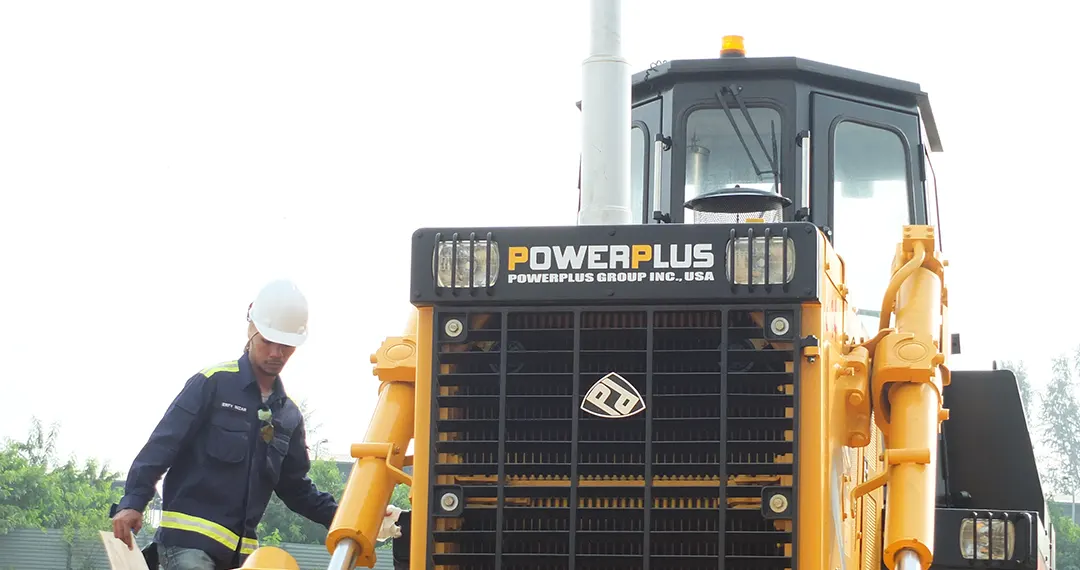 Operator alongside a POWERPLUS D85EX-15 bulldozer
